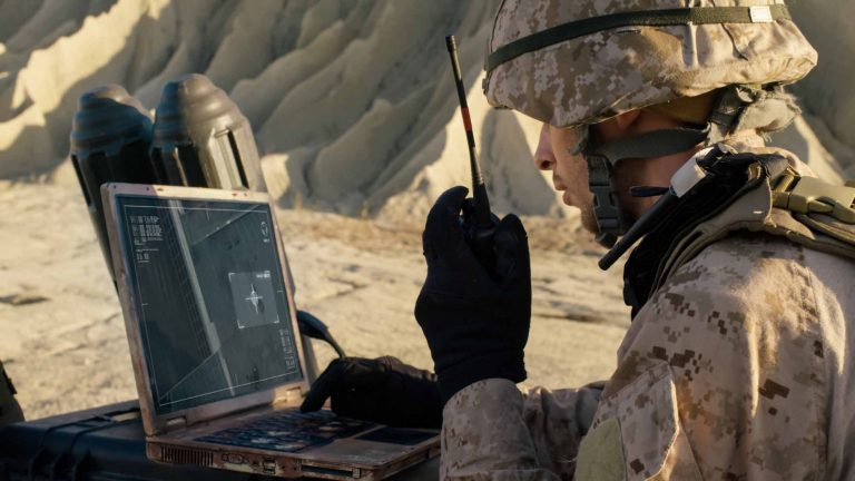 Solider using laptop to view drone