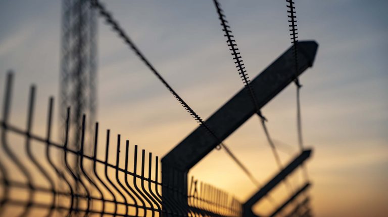 Prison fence with barbed wire