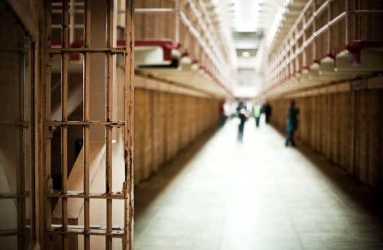 Prison corridor with inmates blurred in the distance